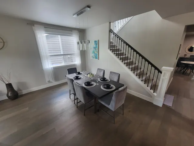Restored dining area with the table set beside the staircase