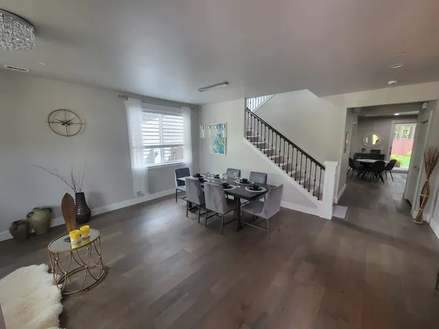 Wide view of the restored living and dining area toward the stairs