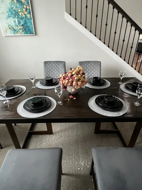 Dining area under the leak with the table still set and water marks on the carpet