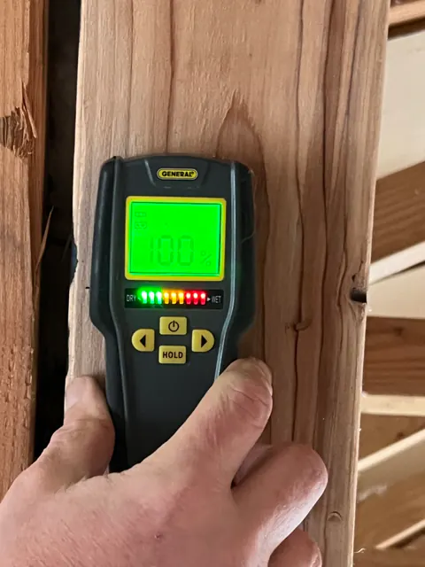 Moisture meter reading 100 percent on an exposed wood stud